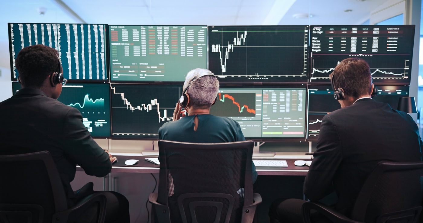 Professional trading workstation with multiple monitors displaying energy market data